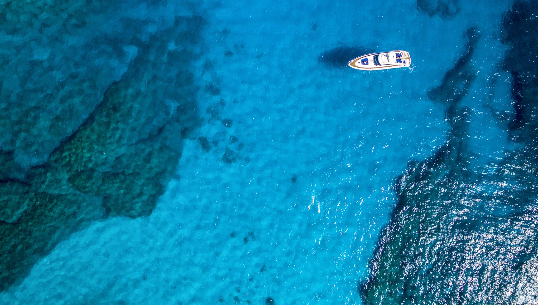 aerial view of a boat floating on shallow water 